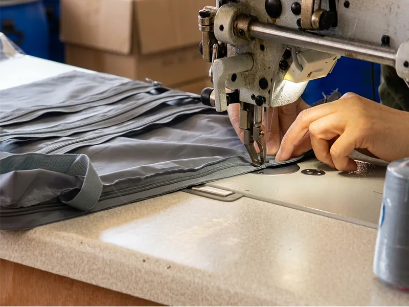 Bag manufacturing factory floor with skilled workers conducting quality inspection